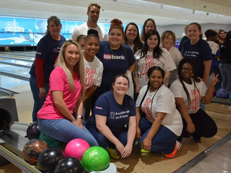 group posing together during Jax 60 bowling fundraiser event in Jackson Michigan