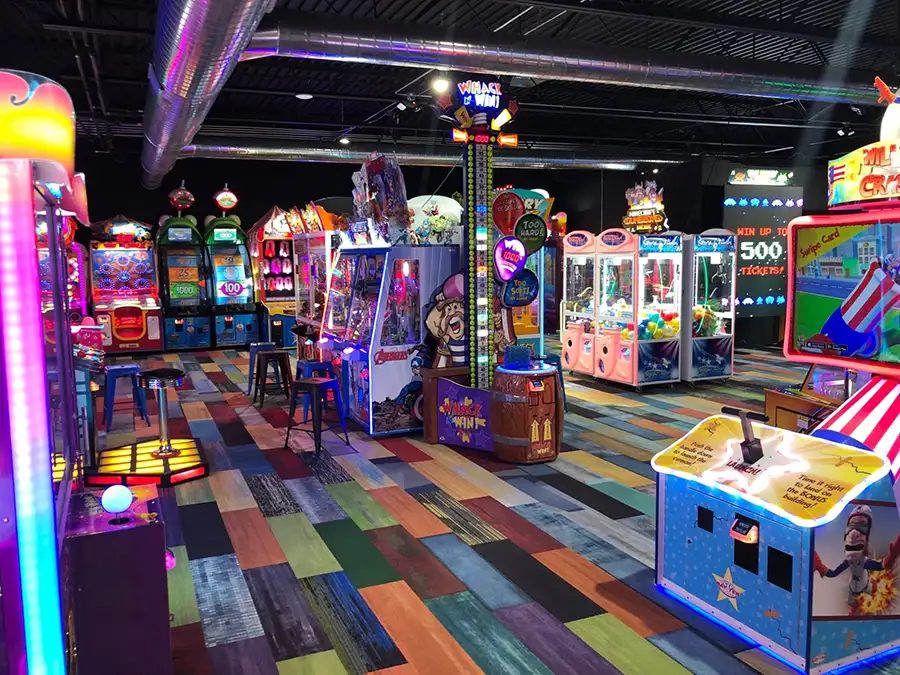 Colorful arcade game floor with claw machines and redemption games at Jax 60 in Jackson, Michigan