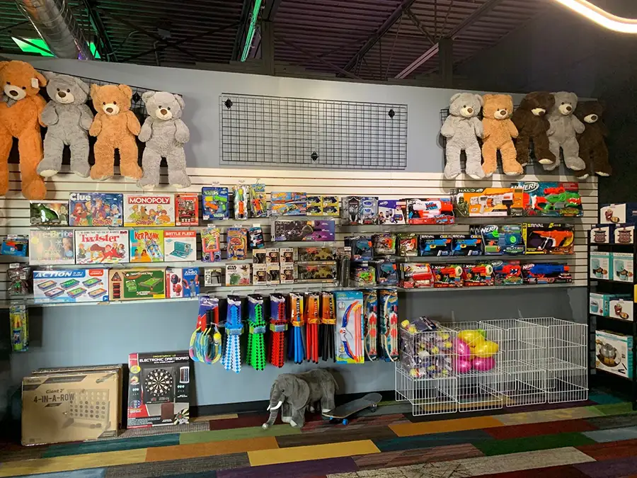 Prize redemption wall with stuffed bears, board games, and toys at Jax 60 in Jackson, Michigan