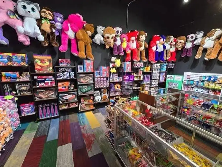 Prize counter stocked with stuffed animals, candy, and toys at Jax 60 in Jackson, Michigan