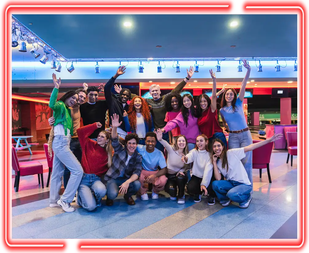 Large group celebrating with raised arms in the bowling lounge at Jax 60 in Jackson, Michigan Kid Bowling Parties