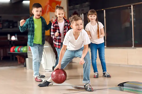 Kids bowling and cheering together at Jax 60 in Jackson, Michigan Kids Party Package