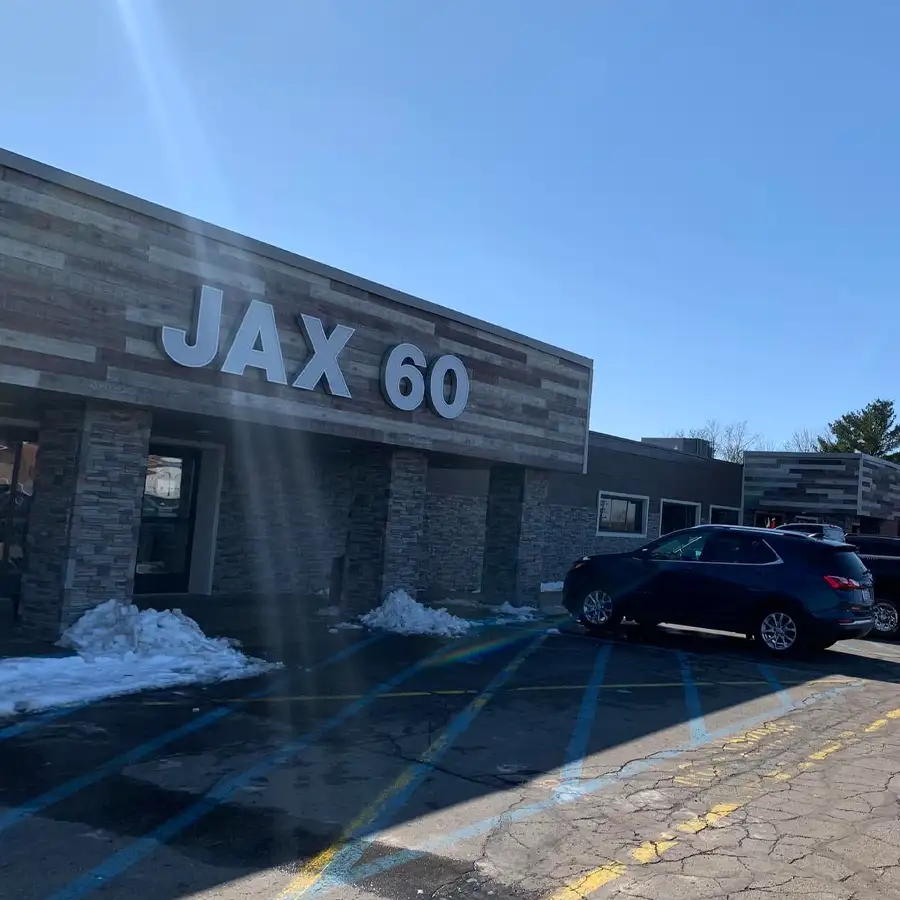 Exterior of the Jax 60 building with snow in the parking lot in Jackson, Michigan