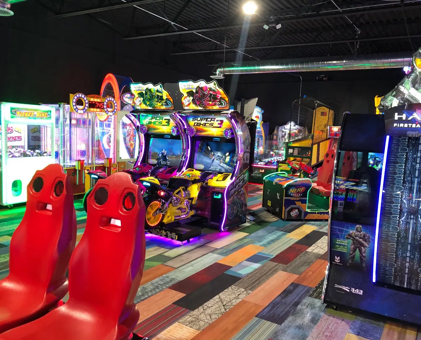 Motorcycle racing arcade machines and light-up seats in the arcade at Jax 60 in Jackson, Michigan